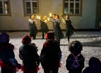 Kuva varhaiskasvatuksen joulupolkutapahtuman ohjelmasta leirikeskuksen pihapiirissä.